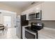 The kitchen includes stainless steel appliances, white cabinets, and tile flooring at 6309 Pontiac Ln, North Port, FL 34287