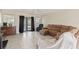 Comfortable living room with tile flooring, neutral walls, and french doors with backyard views at 6309 Pontiac Ln, North Port, FL 34287