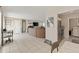 Open-concept living space with neutral tile flooring, blending living and dining areas seamlessly at 6309 Pontiac Ln, North Port, FL 34287