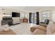 Bright living room featuring modern tile flooring, a flat-screen TV, and french doors at 6309 Pontiac Ln, North Port, FL 34287