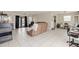 Spacious living area with tile flooring, a comfortable couch, and natural light from french doors at 6309 Pontiac Ln, North Port, FL 34287
