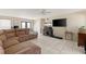 Open-plan living space with tile flooring, comfortable seating and a large television at 6309 Pontiac Ln, North Port, FL 34287