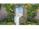 Aerial view of a home with a private backyard pool, surrounded by lush greenery and mature trees at 7122 Turner St, Englewood, FL 34224