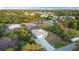 Aerial view of a single-story home in a neighborhood with lush landscaping and scattered homes at 7122 Turner St, Englewood, FL 34224