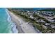 Beautiful aerial view showing the coastline, beach, homes, businesses, and roadways at 7122 Turner St, Englewood, FL 34224