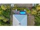 Aerial view of home with in-ground pool, above ground pool, patio and lush landscaping, creating a private backyard oasis at 7122 Turner St, Englewood, FL 34224