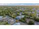 High aerial view of a sunny neighborhood with lush trees and landscaping at 7122 Turner St, Englewood, FL 34224