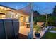 Backyard patio featuring an above ground pool, dining area, hot tub and ambient lighting for evening enjoyment at 7122 Turner St, Englewood, FL 34224