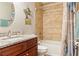 Well-lit bathroom with a granite countertop vanity, decorative art, and tiled shower-tub combo at 7122 Turner St, Englewood, FL 34224
