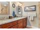 Bathroom featuring double sinks, granite countertops, and a walk-in shower at 7122 Turner St, Englewood, FL 34224