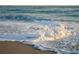 Scenic view of the beach with gentle waves breaking on the shore in a sun-kissed setting at 7122 Turner St, Englewood, FL 34224