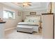 Neutral bedroom featuring a large bed, bench, and large window at 7122 Turner St, Englewood, FL 34224