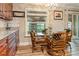 Cozy dining area with hardwood floors, wooden cabinets, and lots of natural light at 7122 Turner St, Englewood, FL 34224