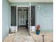Inviting screened front entryway featuring tile flooring and leading to the interior of the home at 7122 Turner St, Englewood, FL 34224
