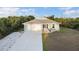 Charming single-story home with a well-manicured lawn and a two-car garage with a long driveway at 7122 Turner St, Englewood, FL 34224