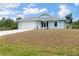 Charming one-story home featuring an attached garage, well-kept lawn, and lovely curb appeal, creating a welcoming atmosphere at 7122 Turner St, Englewood, FL 34224