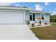 Close-up of a home with a large driveway and a two-car garage, providing convenience and ample parking space at 7122 Turner St, Englewood, FL 34224