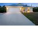 Beautiful home exterior with a spacious driveway, inviting front entrance, and attached garage providing ample parking at 7122 Turner St, Englewood, FL 34224