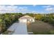 Charming home with lush front yard, long driveway, and garage providing a welcoming curb appeal and convenient parking at 7122 Turner St, Englewood, FL 34224