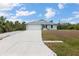 Attractive single-Gathering home with a two-car garage and a well-manicured front yard with lush green grass at 7122 Turner St, Englewood, FL 34224