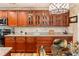 Kitchen with granite countertops, wooden cabinets, black appliances and modern design at 7122 Turner St, Englewood, FL 34224