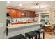 Kitchen with granite countertops, wooden cabinets, and adjacent bar seating at 7122 Turner St, Englewood, FL 34224