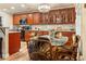 Kitchen with granite countertops, wooden cabinets, and an adjacent dining area at 7122 Turner St, Englewood, FL 34224
