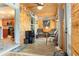 Cozy living area with wood-paneled walls, tiled flooring, and a view of the kitchen at 7122 Turner St, Englewood, FL 34224