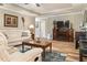 Well-lit living room with hardwood floors, a fireplace, and comfortable seating at 7122 Turner St, Englewood, FL 34224
