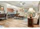 Open-concept living room with hardwood floors, comfortable seating, and a view of the kitchen at 7122 Turner St, Englewood, FL 34224