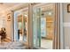 A view of the living room through glass sliding doors, showcasing natural light and hardwood floors at 7122 Turner St, Englewood, FL 34224