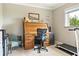 Bright home office features a roll-top desk, comfortable seating, and natural light from the window at 7122 Turner St, Englewood, FL 34224
