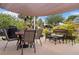 Outdoor patio with dining and lounge seating plus grill, creating the ideal space for entertaining and enjoying backyard views at 7122 Turner St, Englewood, FL 34224