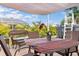 Inviting outdoor patio area with comfortable seating, above ground pool, and shaded pergola for relaxing on warm days at 7122 Turner St, Englewood, FL 34224