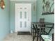 Enclosed patio features tile flooring, table and chairs, and a decorated exterior door at 7122 Turner St, Englewood, FL 34224