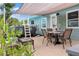 Charming patio area featuring a dining table, above ground pool, and shade covering, perfect for outdoor entertaining at 7122 Turner St, Englewood, FL 34224