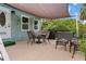 Cozy patio with lounge and dining seating, grill and sun protection, perfect for outdoor enjoyment and relaxation at 7122 Turner St, Englewood, FL 34224