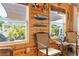 Bright sun room with wooden walls, casual seating, and views of the backyard and pool area at 7122 Turner St, Englewood, FL 34224
