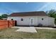 The backyard features a small grass yard, a path and a short fence at 7413 S Elliott St, Tampa, FL 33616