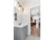 Bathroom features tile floors, a view to the kitchen and a modern vanity at 7413 S Elliott St, Tampa, FL 33616