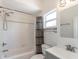 Bathroom features tile walls, a shower-tub combo, and a modern vanity at 7413 S Elliott St, Tampa, FL 33616