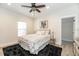 Bright bedroom featuring a ceiling fan, plush rug, and a window offering natural light at 7413 S Elliott St, Tampa, FL 33616