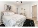 Bright bedroom featuring neutral tones, plush bedding, modern decor, and ample natural light at 7413 S Elliott St, Tampa, FL 33616