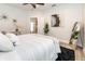 Cozy bedroom with light hardwood floors, soothing decor, and a comfortable, inviting ambiance at 7413 S Elliott St, Tampa, FL 33616