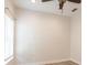 Bright bedroom with a ceiling fan, baseboard trim, and a large window with natural light at 7413 S Elliott St, Tampa, FL 33616