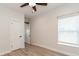 Well-lit bedroom featuring a closet, window, and vinyl flooring at 7413 S Elliott St, Tampa, FL 33616
