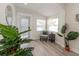 Sunlit entryway with modern decor and a charming chair, creating a warm welcome at 7413 S Elliott St, Tampa, FL 33616