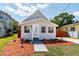 Charming home featuring a well-maintained front yard and a welcoming entrance at 7413 S Elliott St, Tampa, FL 33616