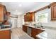 Bright kitchen features stainless steel appliances, granite countertops, and custom wood cabinetry at 7413 S Elliott St, Tampa, FL 33616