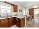 Open kitchen with granite countertops flows into the dining area, featuring a rustic sliding barn door at 7413 S Elliott St, Tampa, FL 33616